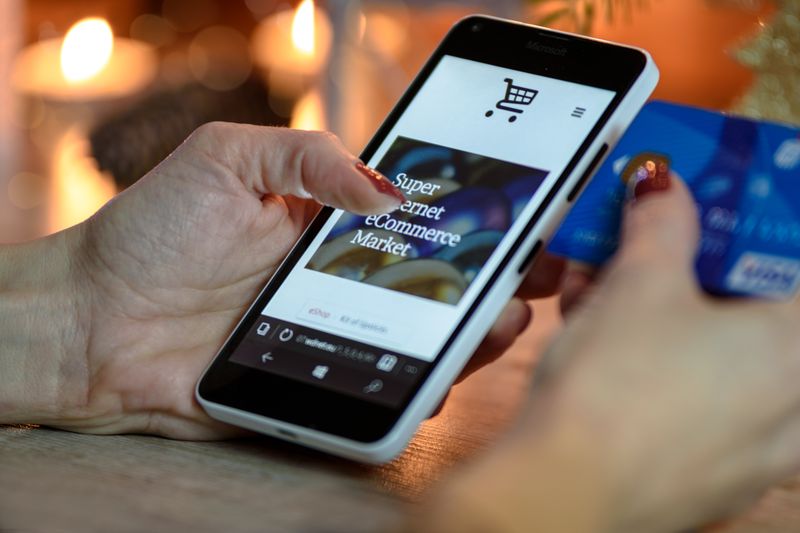 Customer holding a phone while shopping online