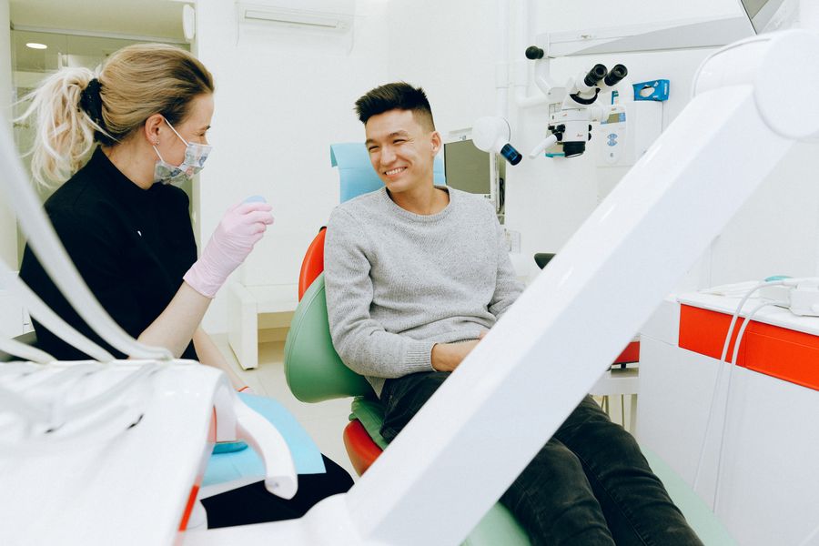 Dentist explaining a treatment plan to a patient with a teeth model